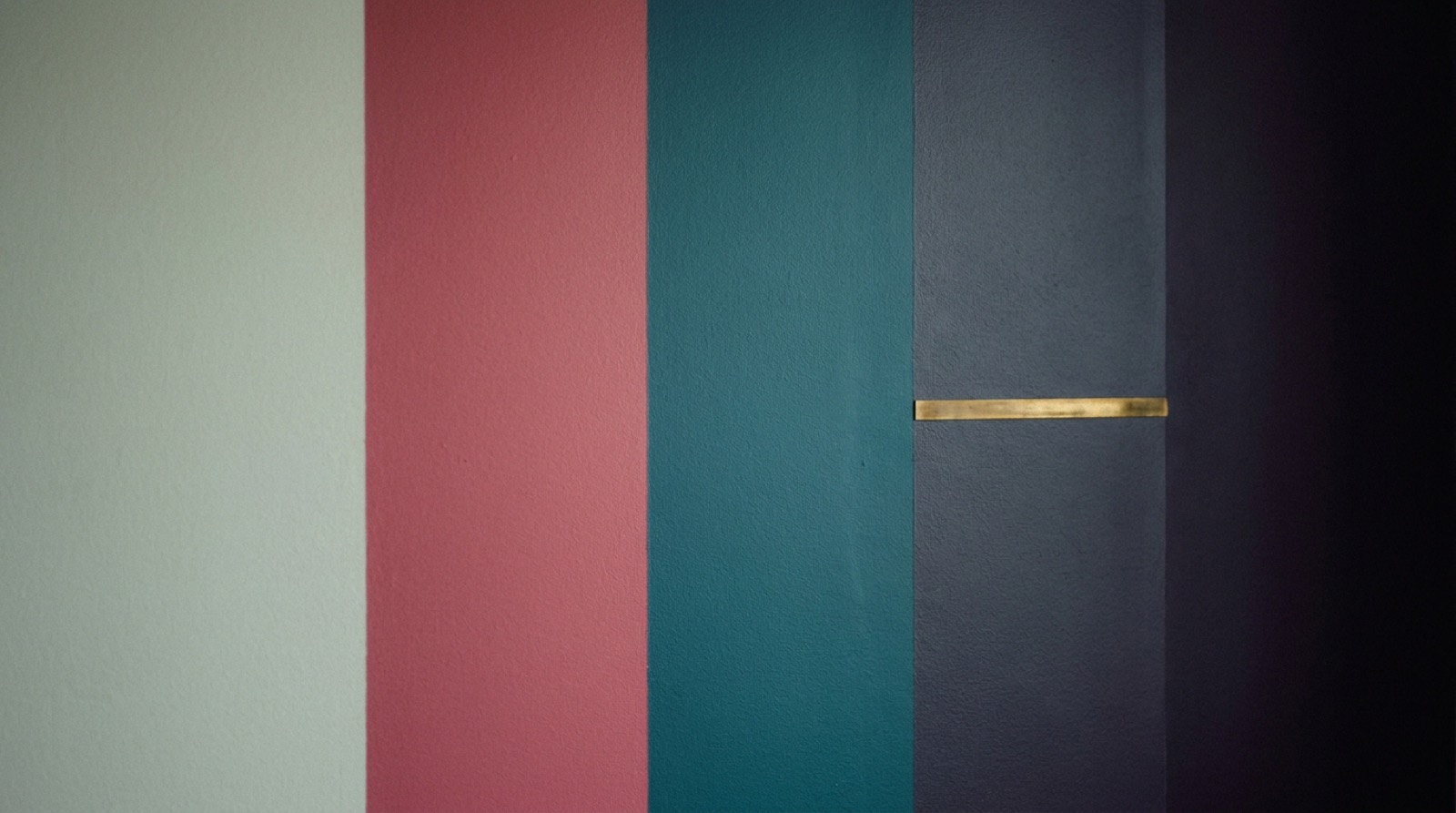 Five flat bands of colour side by side, running from pale sage through rose and
                  teal into deep violet-black, with a single thin brass line across them.